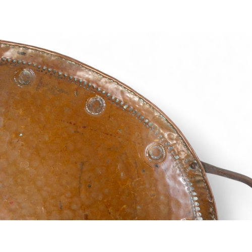 79 - John Pearson (British 1858-1930) a large oval copper tray - with a planished finish and domed border... 