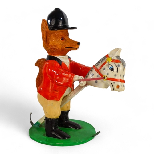 86 - A 20th century fox figure - wearing hunting pink and astride a hobby horse, 53cm high.