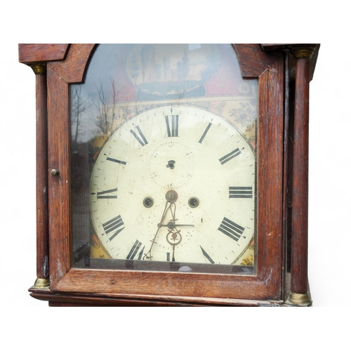 922 - An early 19th century oak longcase clock - the painted dial with floral spandrels and Italianate lan... 