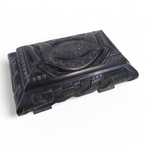 93 - An Anglo Indian 20th century black slate casket - deeply carved with a castellated design and raised... 