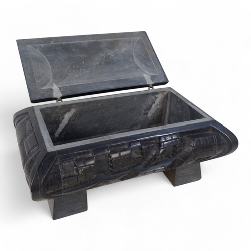 93 - An Anglo Indian 20th century black slate casket - deeply carved with a castellated design and raised... 