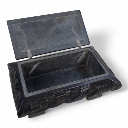 93 - An Anglo Indian 20th century black slate casket - deeply carved with a castellated design and raised... 