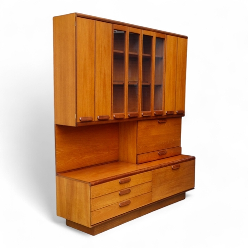 941 - A teak 'Chichester Highboard' side cabinet retailed by White & Newton of Portsmouth - the upper sect... 