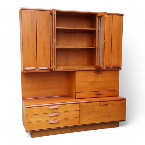 941 - A teak 'Chichester Highboard' side cabinet retailed by White & Newton of Portsmouth - the upper sect... 