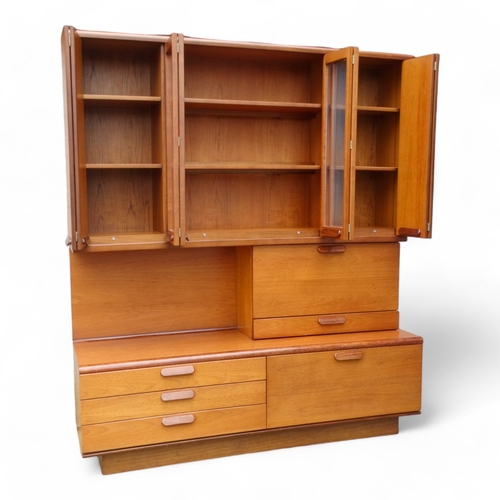 941 - A teak 'Chichester Highboard' side cabinet retailed by White & Newton of Portsmouth - the upper sect... 