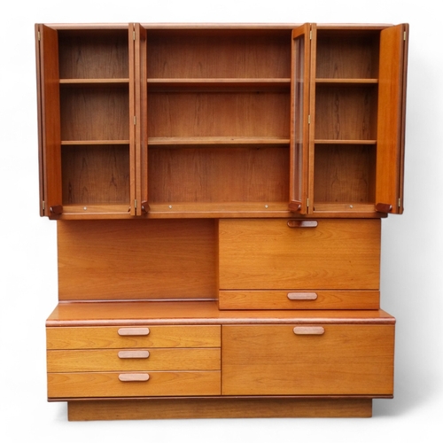 941 - A teak 'Chichester Highboard' side cabinet retailed by White & Newton of Portsmouth - the upper sect... 