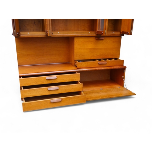 941 - A teak 'Chichester Highboard' side cabinet retailed by White & Newton of Portsmouth - the upper sect... 