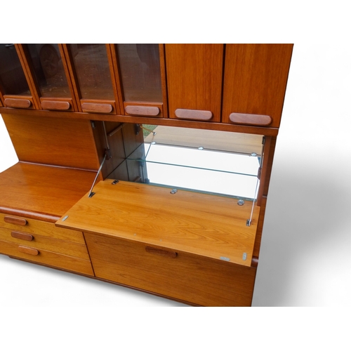 941 - A teak 'Chichester Highboard' side cabinet retailed by White & Newton of Portsmouth - the upper sect... 