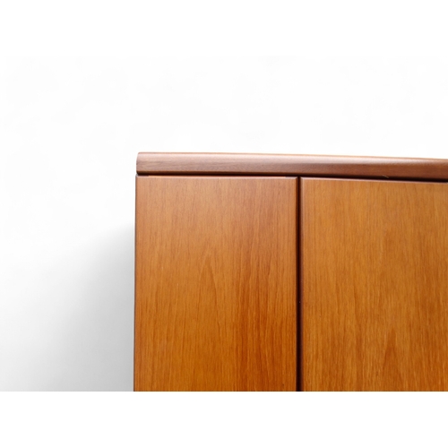 941 - A teak 'Chichester Highboard' side cabinet retailed by White & Newton of Portsmouth - the upper sect... 