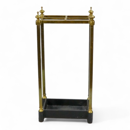 943 - A late 19th century brass and cast iron stick stand - rectangular with square supports, 61cm high.