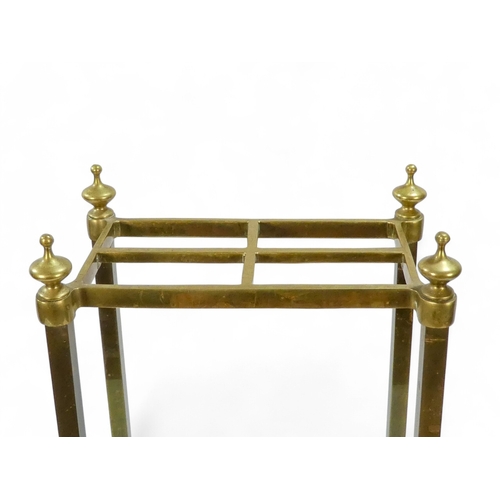 943 - A late 19th century brass and cast iron stick stand - rectangular with square supports, 61cm high.