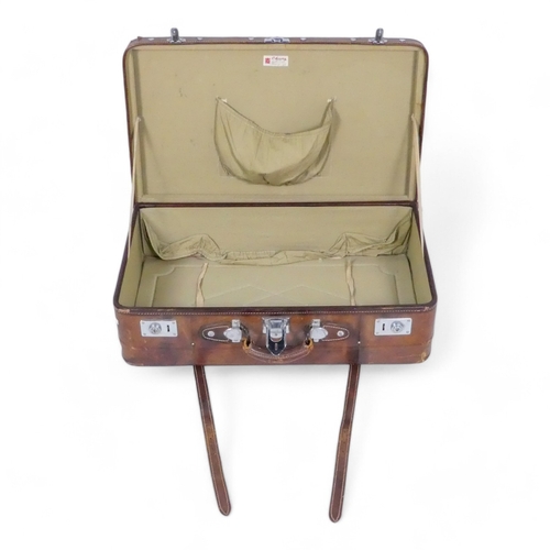 944 - A mid 20th century tan leather suitcase - with chrome fittings, 70cm wide, together with a tan leath... 