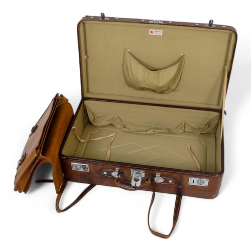 944 - A mid 20th century tan leather suitcase - with chrome fittings, 70cm wide, together with a tan leath... 