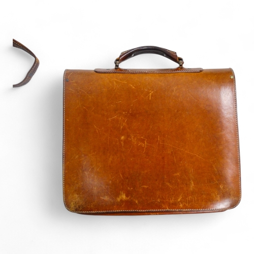 944 - A mid 20th century tan leather suitcase - with chrome fittings, 70cm wide, together with a tan leath... 