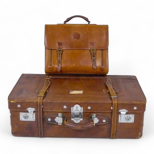 944 - A mid 20th century tan leather suitcase - with chrome fittings, 70cm wide, together with a tan leath... 