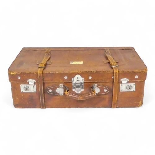 944 - A mid 20th century tan leather suitcase - with chrome fittings, 70cm wide, together with a tan leath... 