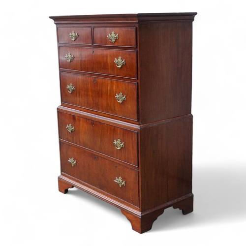 945 - A George II walnut chest on chest - of small proportions, the upper section with an arrangement of t... 