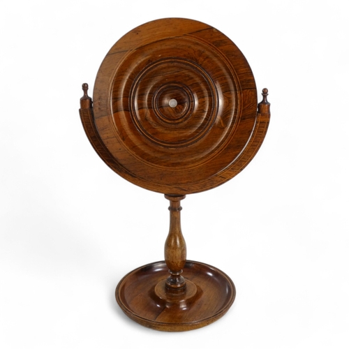 96 - A William IV rosewood shaving mirror - with a circular plate within a tilting frame on a turned supp... 