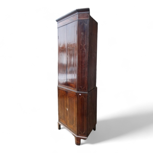 967 - A George III mahogany standing corner cupboard - with a pair of doors enclosing shelves, the lower s... 