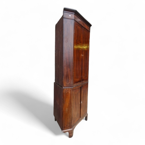 967 - A George III mahogany standing corner cupboard - with a pair of doors enclosing shelves, the lower s... 