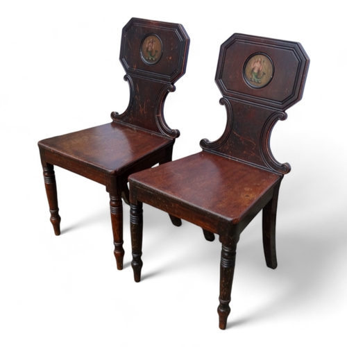 971 - A pair of George IV mahogany hall chairs - the tablet shaped backs with canted corners and decorated... 