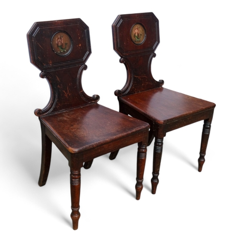 971 - A pair of George IV mahogany hall chairs - the tablet shaped backs with canted corners and decorated... 