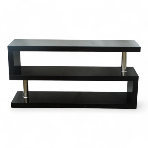 972 - A contemporary gloss black two tier stand - of S form with chrome columns, 120 x 35 x 60cm.