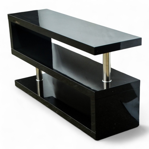 972 - A contemporary gloss black two tier stand - of S form with chrome columns, 120 x 35 x 60cm.