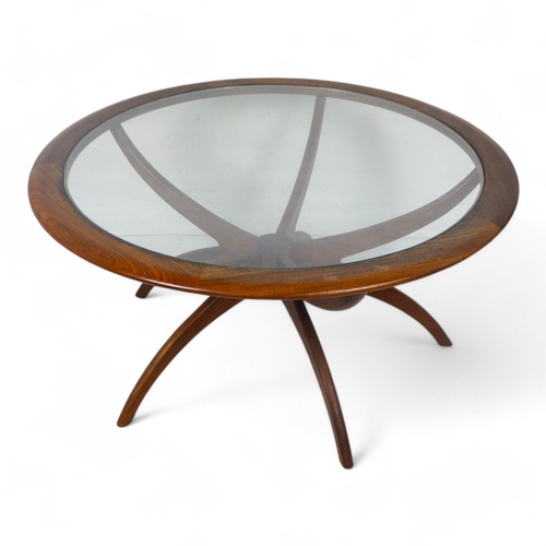 974 - Victor Wilkins for G-Plan - a teak Astro Spider circular table, with inset clear glass top raised on... 