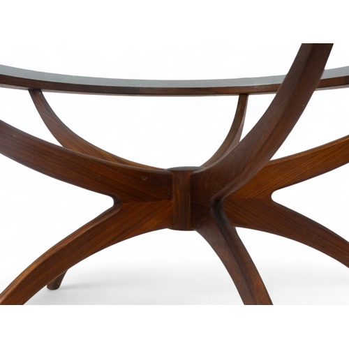 974 - Victor Wilkins for G-Plan - a teak Astro Spider circular table, with inset clear glass top raised on... 