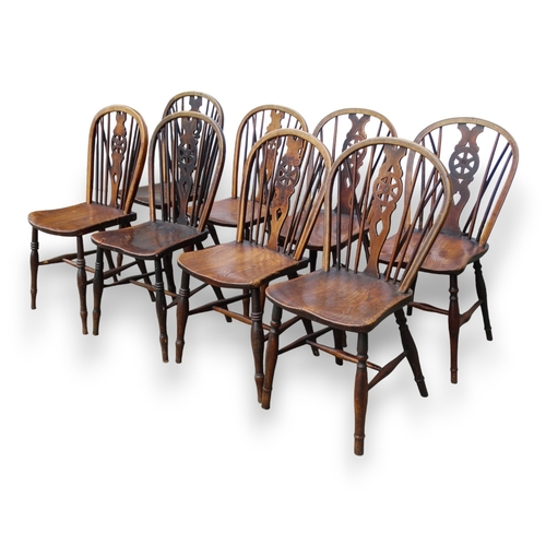 979 - A 19th century harlequin set of eight ash and elm wheel back Thames Valley chairs - with pierced spl... 