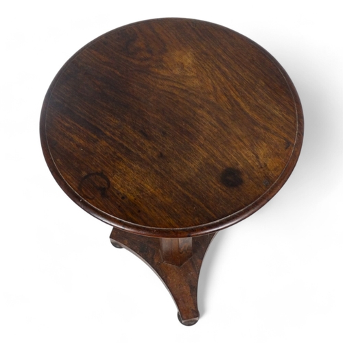 980 - An early Victorian rosewood occasional table - the circular top above a tapering octagonal support a... 