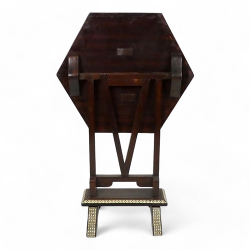 982 - An early 20th century Moorish tilt top table - with a hexagonal top intricately inlaid with bone and... 