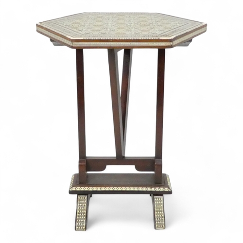 982 - An early 20th century Moorish tilt top table - with a hexagonal top intricately inlaid with bone and... 