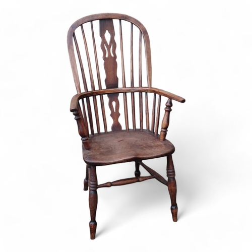 987 - A 19th century ash and elm Windsor chair - with pierced vase shaped splat, solid contoured seat and ... 