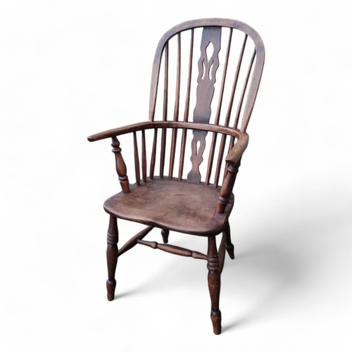 987 - A 19th century ash and elm Windsor chair - with pierced vase shaped splat, solid contoured seat and ... 