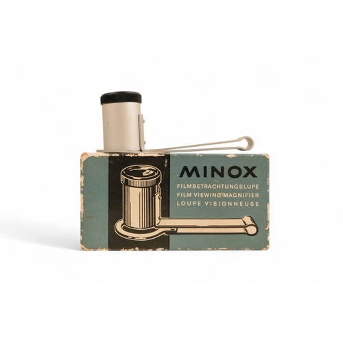 141 - A collection of Minox camera accessories - including camera clamp, viewing magnifier, binocular atta... 