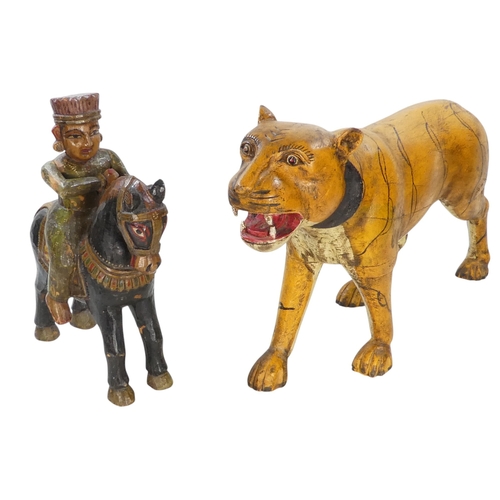 154 - A 20th century carved hardwood and polychrome painted tiger - 59cm wide, together with another of an... 