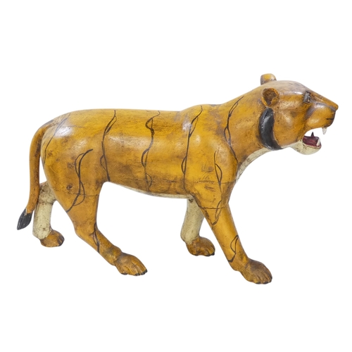 154 - A 20th century carved hardwood and polychrome painted tiger - 59cm wide, together with another of an... 