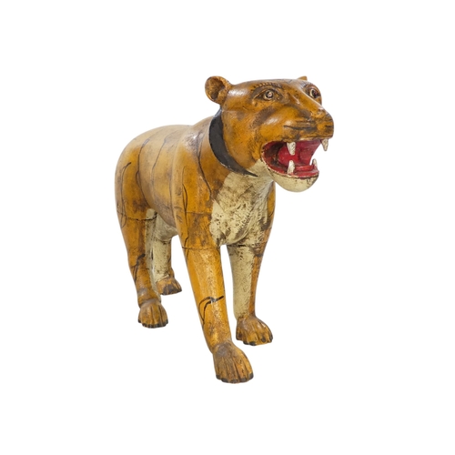 154 - A 20th century carved hardwood and polychrome painted tiger - 59cm wide, together with another of an... 