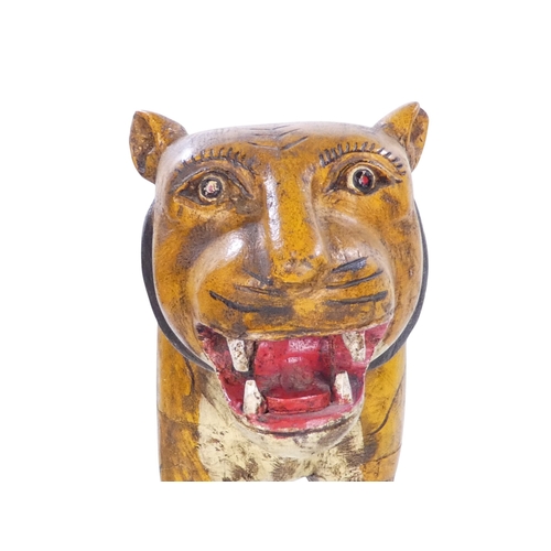 154 - A 20th century carved hardwood and polychrome painted tiger - 59cm wide, together with another of an... 