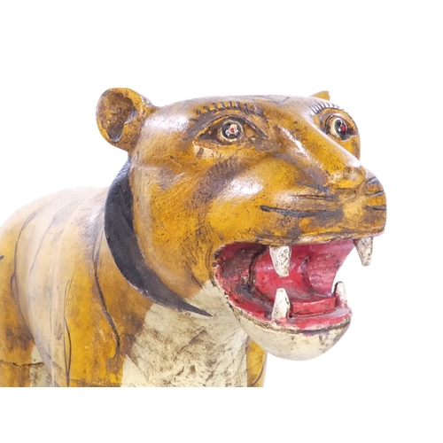 154 - A 20th century carved hardwood and polychrome painted tiger - 59cm wide, together with another of an... 