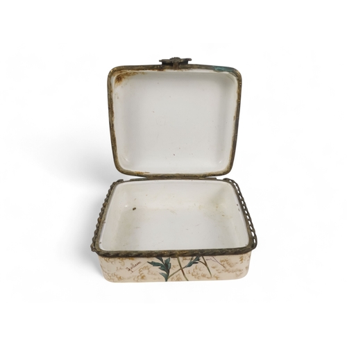 215 - A late 19th century continental ceramic box - rectangular with gilt mounts and decorated with summer... 