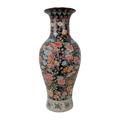 226 - A large baluster shaped vase - decorated in enamels with chrysanthemums and flowers on a black groun... 