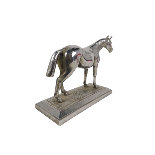 24 - An early 20th century chrome casting of a horse - standing on a rectangular base, 25cm wide.