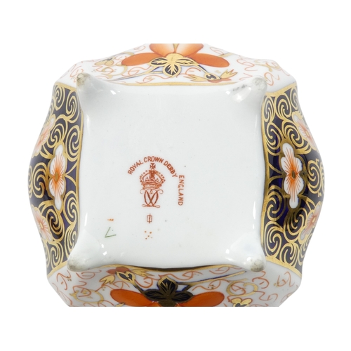 253 - A Royal Crown Derby inkwell - circular with cover and decorated in the Imari style, 8cm diameter, to... 