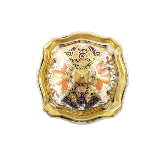 253 - A Royal Crown Derby inkwell - circular with cover and decorated in the Imari style, 8cm diameter, to... 