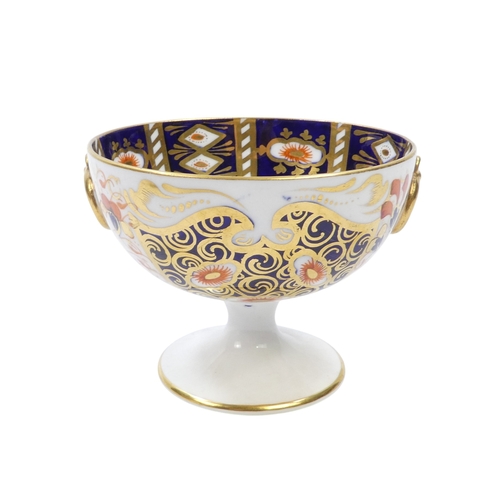 257 - A Royal Crown Derby chalice - decorated in an Imari pattern with gilt ring handles, 8cm high, togeth... 