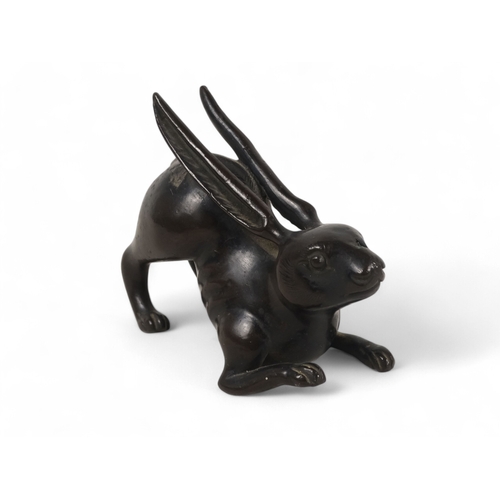 329 - A Japanese bronze rabbit - Meiji period (1865-1912) modelled in a squatting position with engraved f... 