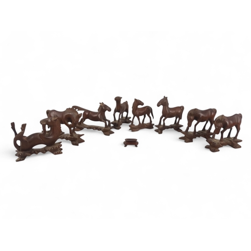 330 - Eight 20th century Japanese carved hardwood horses - arranged in differing poses, 10cm high. (8)